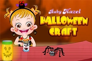 Küçük bir kız çocuğu, önünde örümcek figürü ve ince bir şerit üzerinde Halloween temalı el işleriyle oturuyor