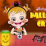 Küçük bir kız çocuğu, önünde örümcek figürü ve ince bir şerit üzerinde Halloween temalı el işleriyle oturuyor