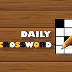 Ahşap zeminde beyaz ve siyah harflerle DAILY CROSSWORD yazısı ve yanında kalemli bir kare bulmaca
