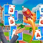 Sarı saçlı bir kadın, önünde yer alan kartlarla bir parkta duruyor ve yanında bir roket havalanıyor