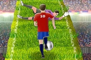 Kırmızı forma giymiş bir futbolcu, yeşil bir yol üzerinde top sürerken, kaleci yere uzanmış durumda