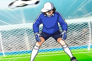 Kep takmış bir kaleci mavi forma giymiş, bir futbol topunu kurtarmaya hazırlanıyor