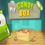 Yeşil, sevimli canavar figürü ve içinde şekerler olan bir kutu, My Candy Box yazılı tabela ile