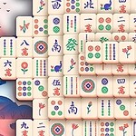 Farklı desen ve sembollere sahip taşlarla dolu bir ekran önünde, maneki-neko heykeli ve uzakdoğulu pagoda tarzı bir yapı bulunmaktadır