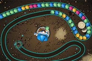 Renkli topların spiral bir yolda ilerlediği, ortada mavi bir yapının bulunduğu görsel